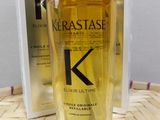 the bottle of kerastasee elixir ultimate hair oil next to a box of kerastasee elixir ultimate hair oil