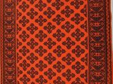 an orange and black rug hanging on a wall