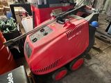 une voiture rouge qui est garée dans le garage