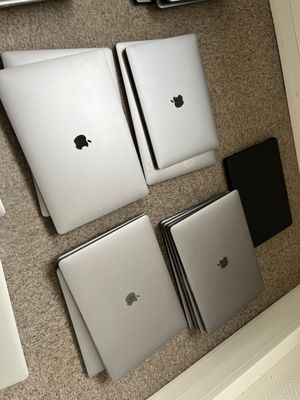 four laptops sitting on the floor next to each other
