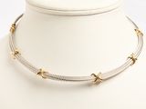an image of a white mannequin with a silver and gold necklace on it