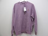 a close up of a purple sweater hanging on a hanger