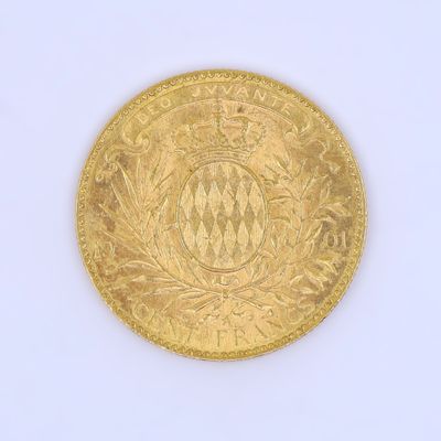 an old gold coin with a crown on it on a white surface
