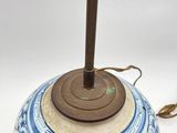 a blue and white vase with a wooden stick in it