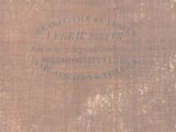 an old book with writing on it sitting on a table