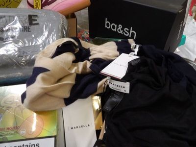 a pile of clothing and a bag on a table