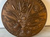 a close up of a metal plate with a flower design on it