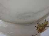 a close up of a vase with a flower design on it