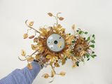 a person that is holding a clock with flowers on it