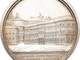 an image of a silver medal with a picture of a building in the background