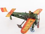 a toy airplane that is sitting on a white surface