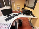a desk with a computer and a printer on it