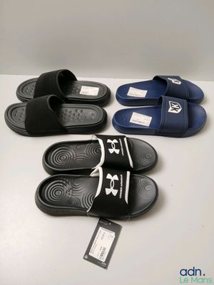 three pairs of black and white slippers on a white surface