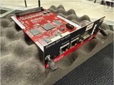 an image of a red and black pci - e card on top of a blanket