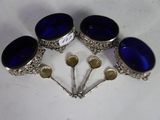 six blue glass buttons are arranged in a circle on a white surface
