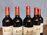 four bottles of wine are lined up on a table