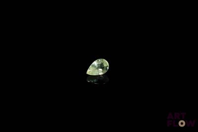 a close up of a green diamond on a black surface