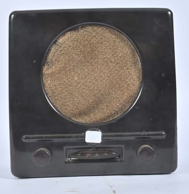 a black radio with a brown disc on it