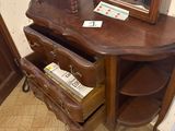 a wooden table with a mirror and a magazine rack on it