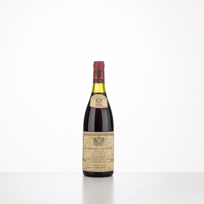 a bottle of wine sitting on top of a white table