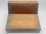 an old wooden desk with a drawer on top of it
