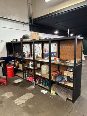 a garage with a lot of shelves and tools on it