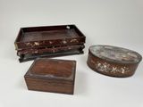 three small wooden boxes are sitting on a white surface