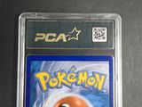the pokemon card is in a plastic holder on a table