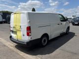 a white van parked in a parking lot with a yellow tape on the back