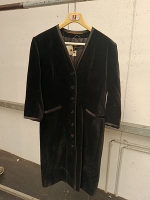 a black jacket hanging on a hanger in a room