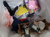 a wooden crate with shoes and other items in it