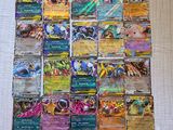 a close up of a pile of pokemon cards on a table