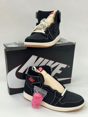 a pair of black and white sneakers with pink laces on them