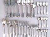 a lot of silver spoons and forks on the table