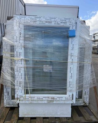 a large white refrigerator sitting on a pallet in a warehouse