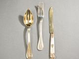three forks, a spoon, and a knife on a table