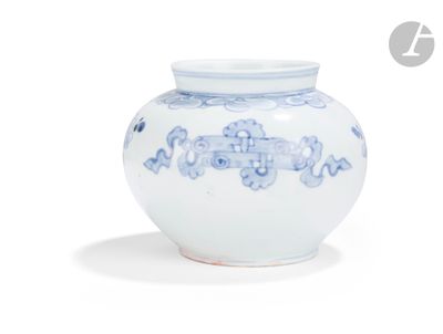 a blue and white vase sitting on a white surface