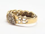 a close up of a gold ring with diamonds on a white surface