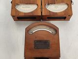 two old fashioned wooden clocks sitting on top of a white table