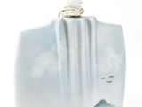 a picture of a blue and white vase with a mountain scene on it