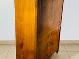a wooden cabinet with a marble top on a tiled floor