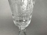 a glass with a design on it on a table