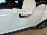 a white car with a measuring tape on the side of it