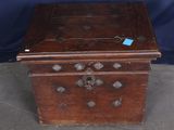 a small wooden box with a blue tag on it