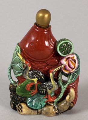 a figurine of a man sitting on a rock with a dragon