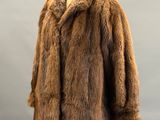 a brown fur coat on a mannequin stand