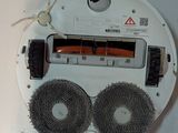 a close up of a white device with two wheels attached to it