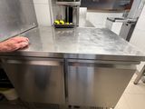a man that is standing in a kitchen with a dishwasher