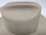 a close up of a white hat on a white surface