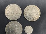 a close up of three different coins on a black surface